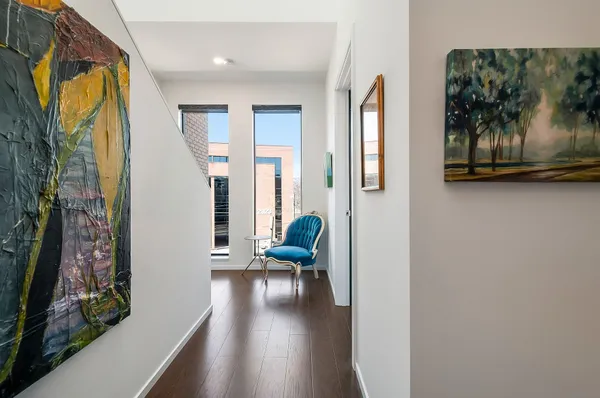 a living room with furniture and a painting on the wall