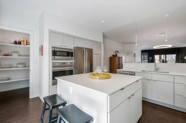a kitchen with a sink a stove and chairs