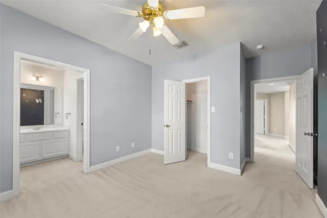 an empty room with fan and entrance