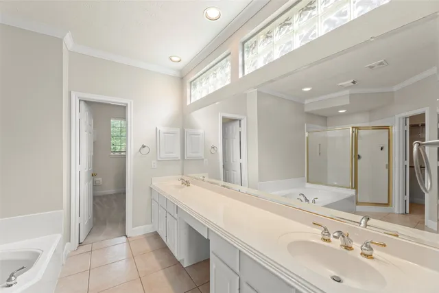 a bathroom with a double vanity sink mirror and shower