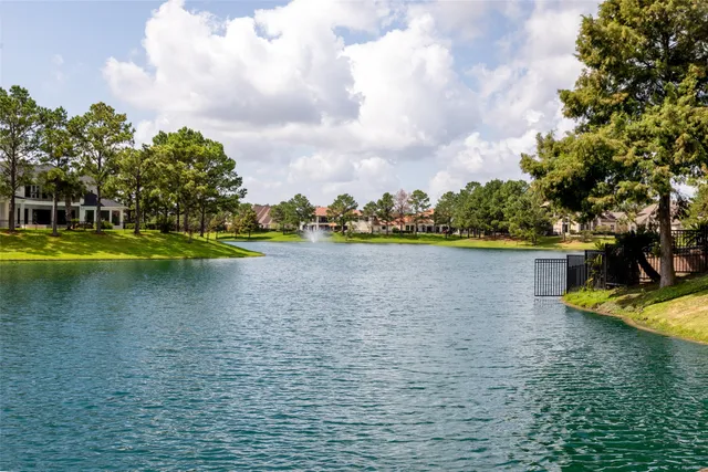 a view of a lake with houses in the back