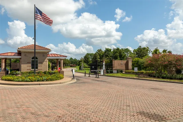 a front view of a house with a big yard and potted plants