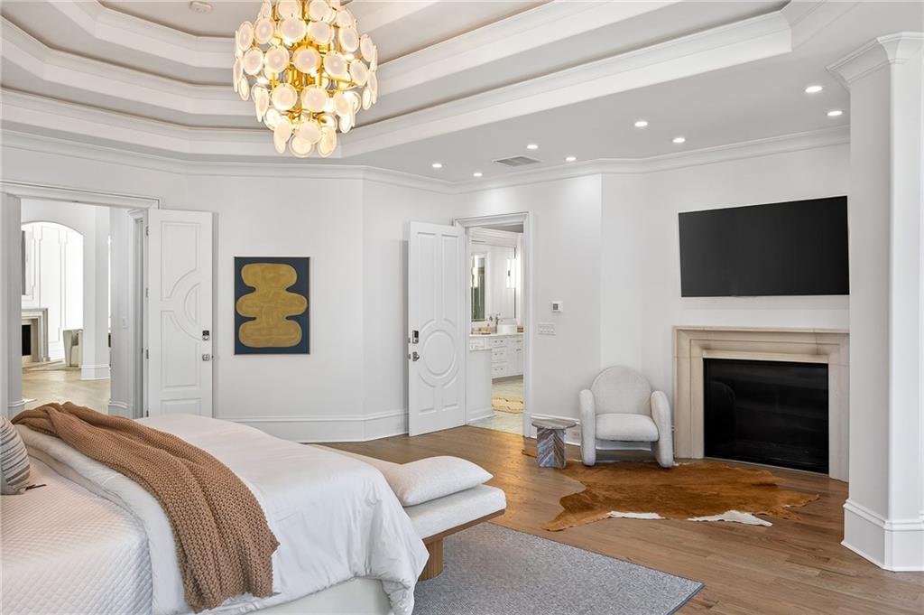 5320 Riverview Road Northwest Atlanta, GA 30339 - Photo 21 of 83 a spacious bedroom with a bed and a chandelier