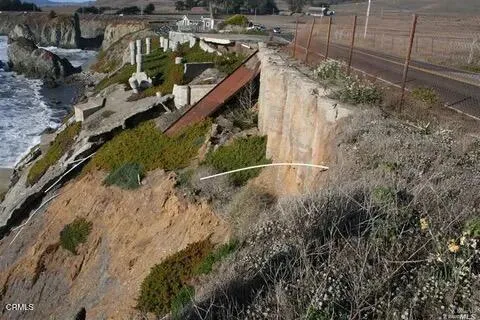 a view of a yard with wooden fence
