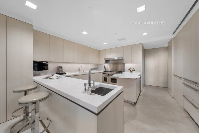 a kitchen with a sink a stove and cabinets