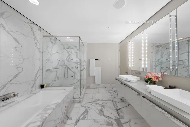 a bathroom with a granite countertop tub sink and shower