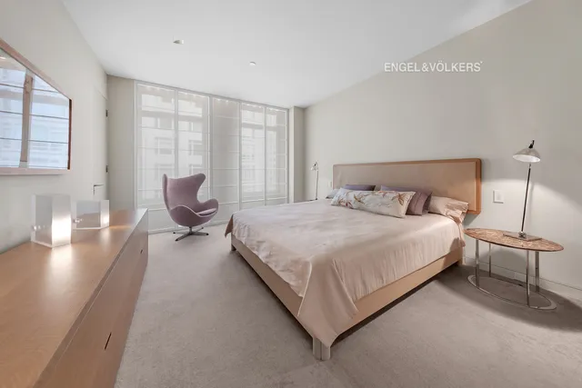 a bedroom with a bed chair and window