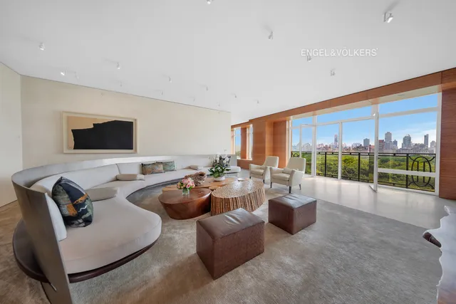 a living room with furniture a lamp and a floor to ceiling window