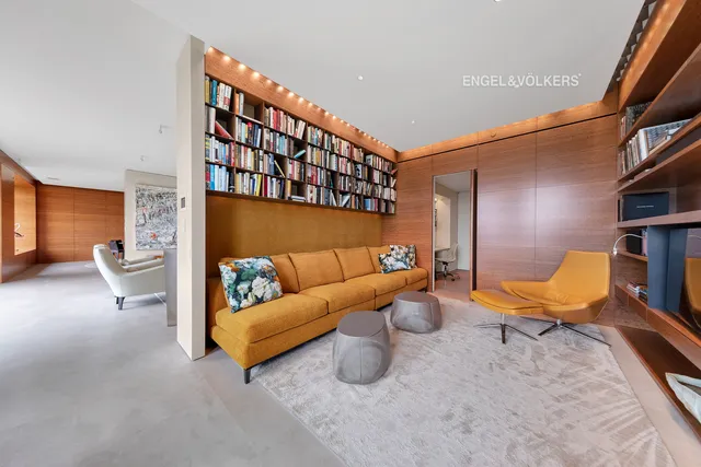 a living room with furniture a fireplace and a large window