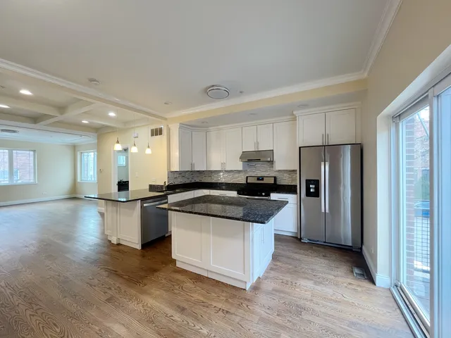 a large white kitchen with a large window