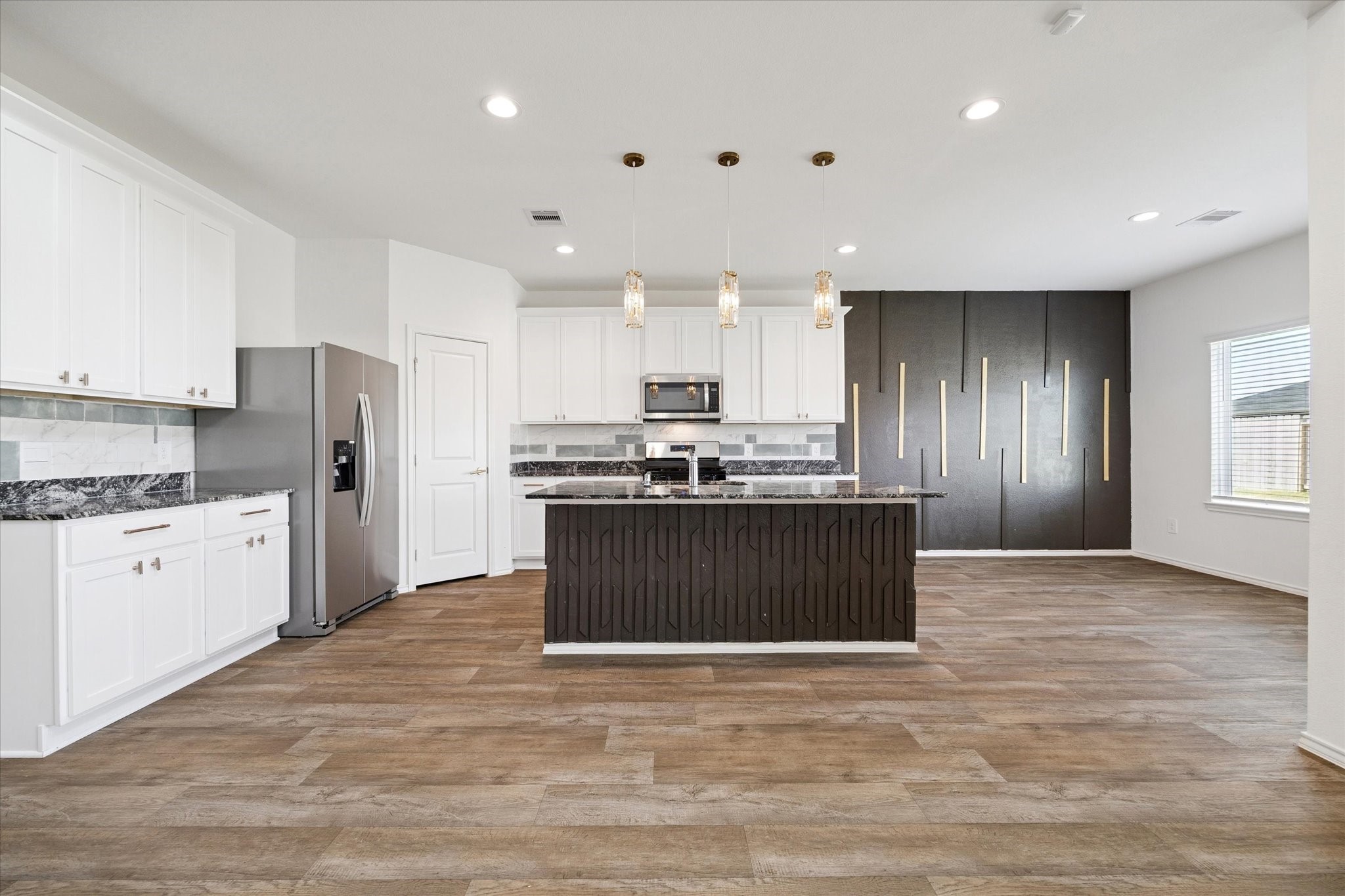 2938 Bur Landing Lane Rosenberg, TX 77469 - Photo 10 of 21 a kitchen with stainless steel appliances granite countertop a refrigerator a sink dishwasher a stove and white cabinets with wooden floor