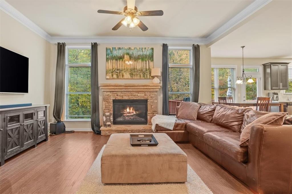 821 Tramore Court Acworth, GA 30102 - Photo 12 of 63 a living room with furniture a flat screen tv and a fireplace