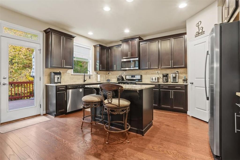 821 Tramore Court Acworth, GA 30102 - Photo 18 of 63 a kitchen with kitchen island a sink stove and refrigerator