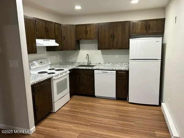 a kitchen with a white stove top oven and refrigerator