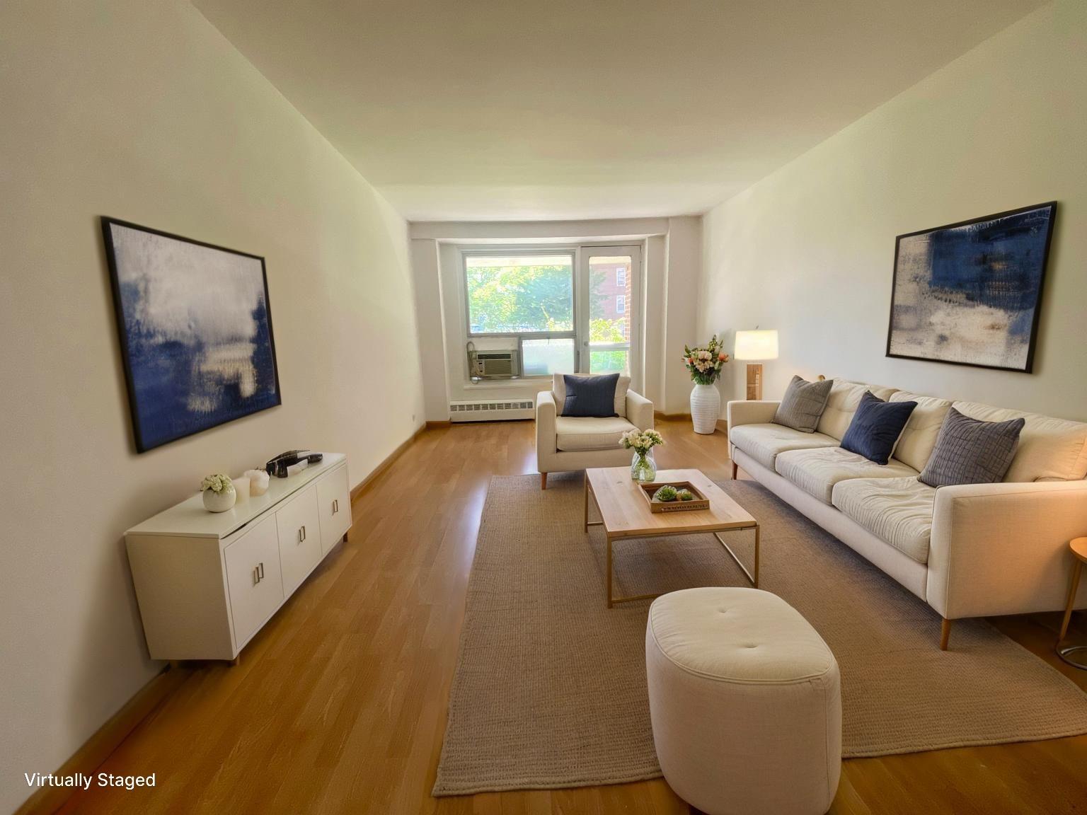 98-05 63rd Road, Unit 1C Queens, NY 11374 - Photo 2 of 11 a living room with furniture and a large window