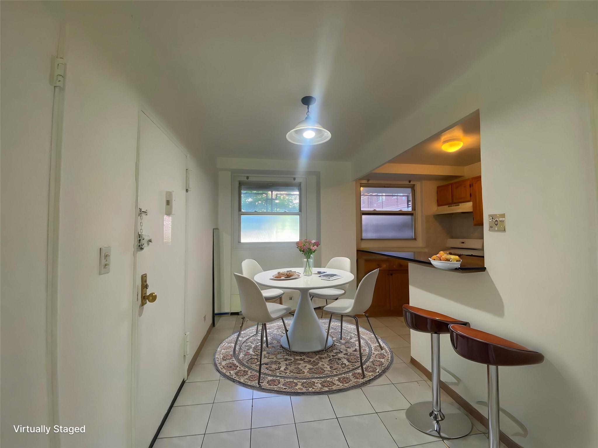 98-05 63rd Road, Unit 1C Queens, NY 11374 - Photo 6 of 11 a living room with a couch and a chandelier