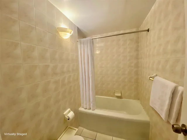 a bathroom with a shower and a tub