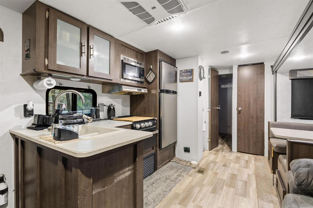 988 County Road Gordonville, TX 76245 - Photo 13 of 35 a kitchen with stainless steel appliances a sink stove and refrigerator