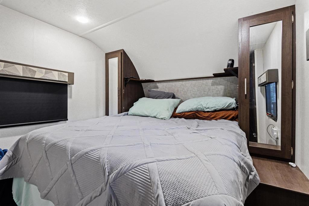 988 County Road Gordonville, TX 76245 - Photo 16 of 35 a bedroom with a bed and a flat screen tv