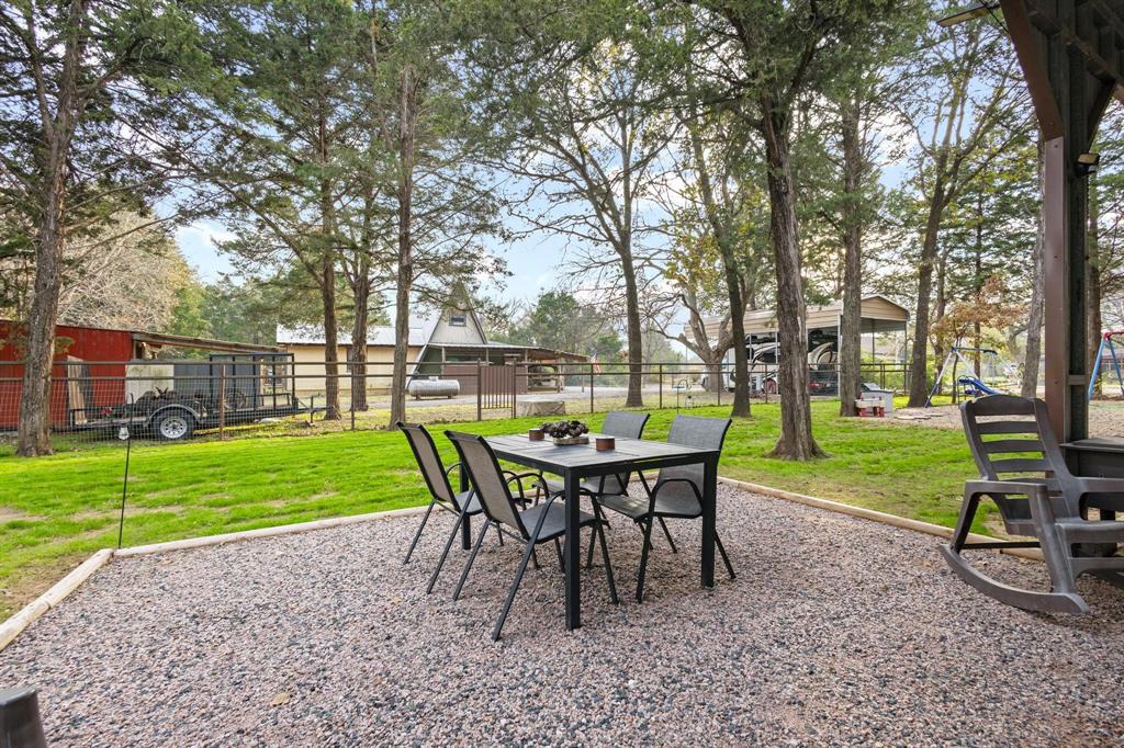 988 County Road Gordonville, TX 76245 - Photo 20 of 35 a view of a yard with table and chairs