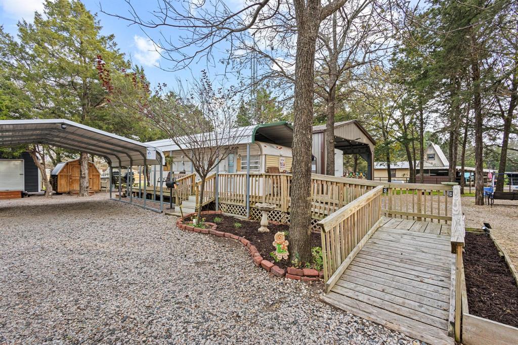 988 County Road Gordonville, TX 76245 - Photo 4 of 35 a view of street with large trees and sign board