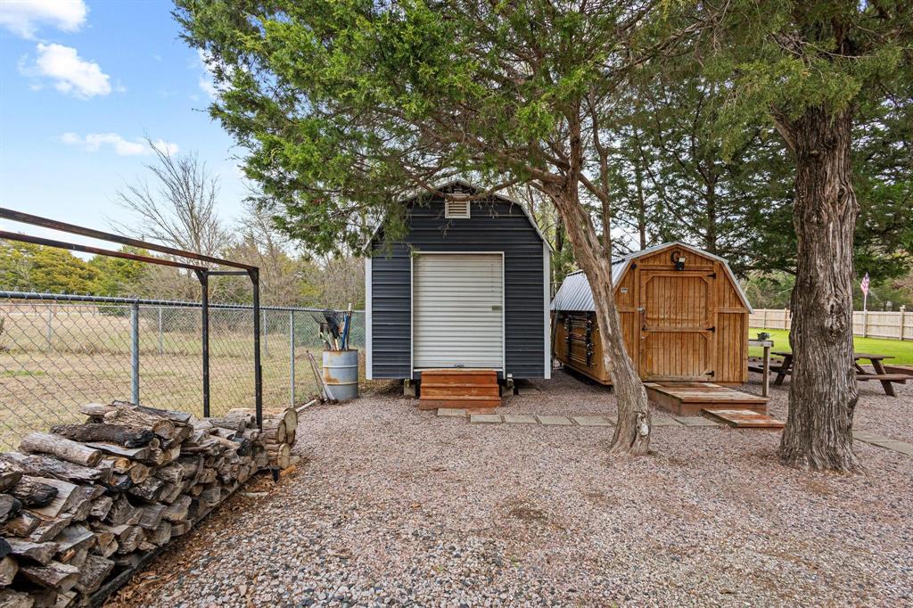 988 County Road Gordonville, TX 76245 - Photo 8 of 35 a backyard of a house with sofas and wooden fence