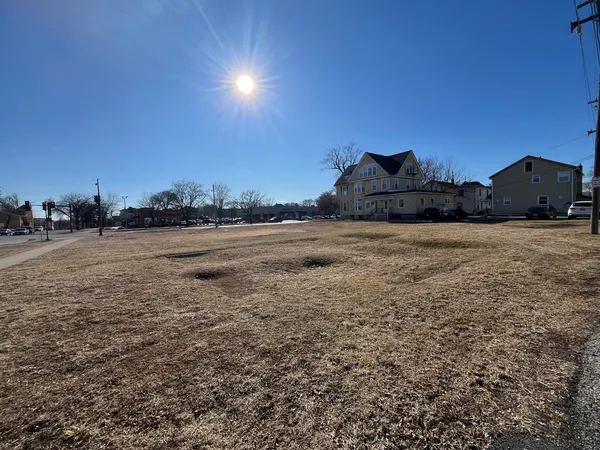 a view of dirt road with a building in the background