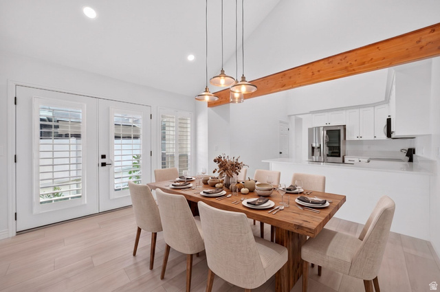 6969 South 855 East Midvale, UT 84047 - Photo 3 of 55 Dining area featuring wood-finish flooring and a vaulted ceiling with a prominent wood beam