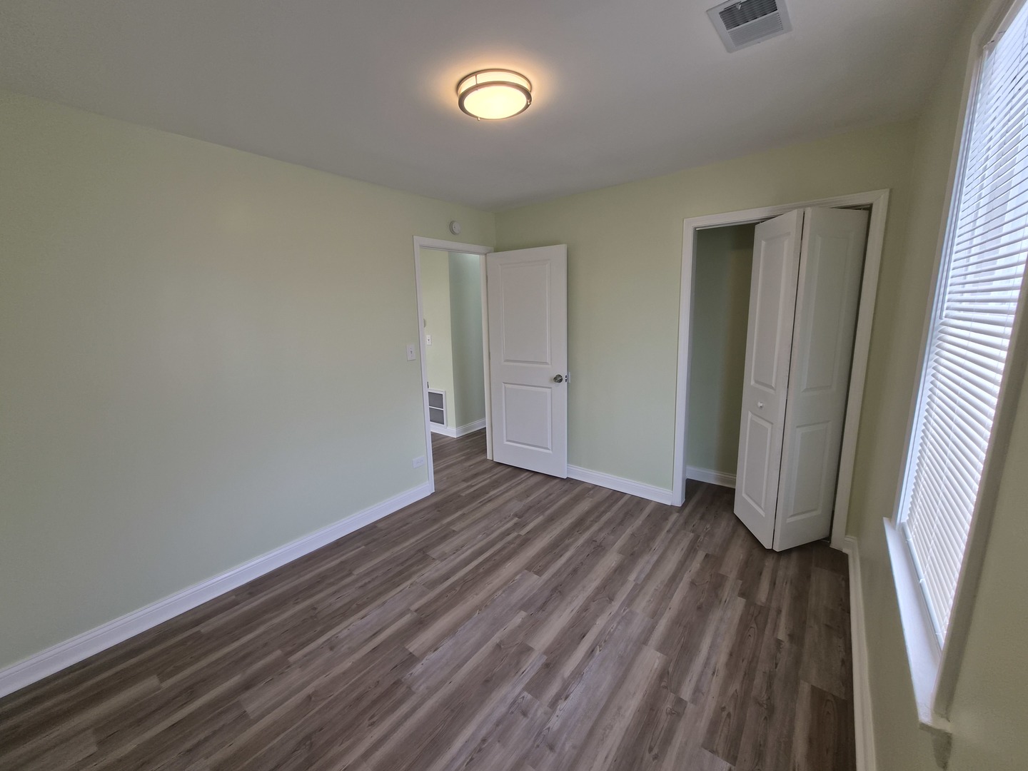 1234 West 72nd Street Chicago, IL 60636 - Photo 18 of 35 wooden floor in an empty room with a window