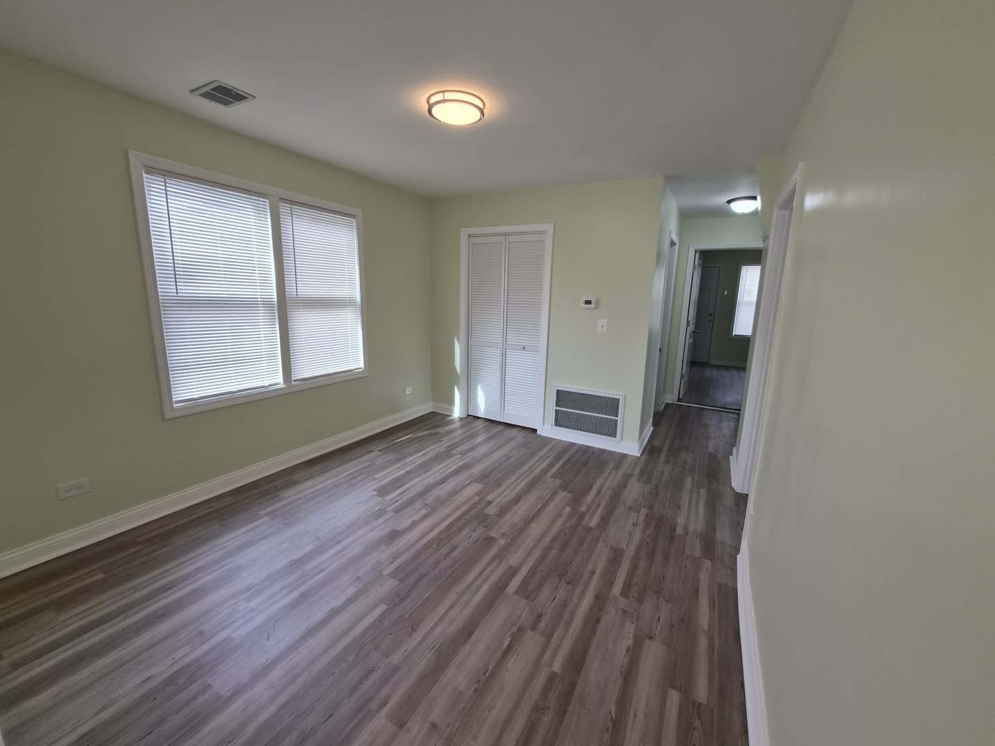 1234 West 72nd Street Chicago, IL 60636 - Photo 20 of 35 an empty room with wooden floor and windows
