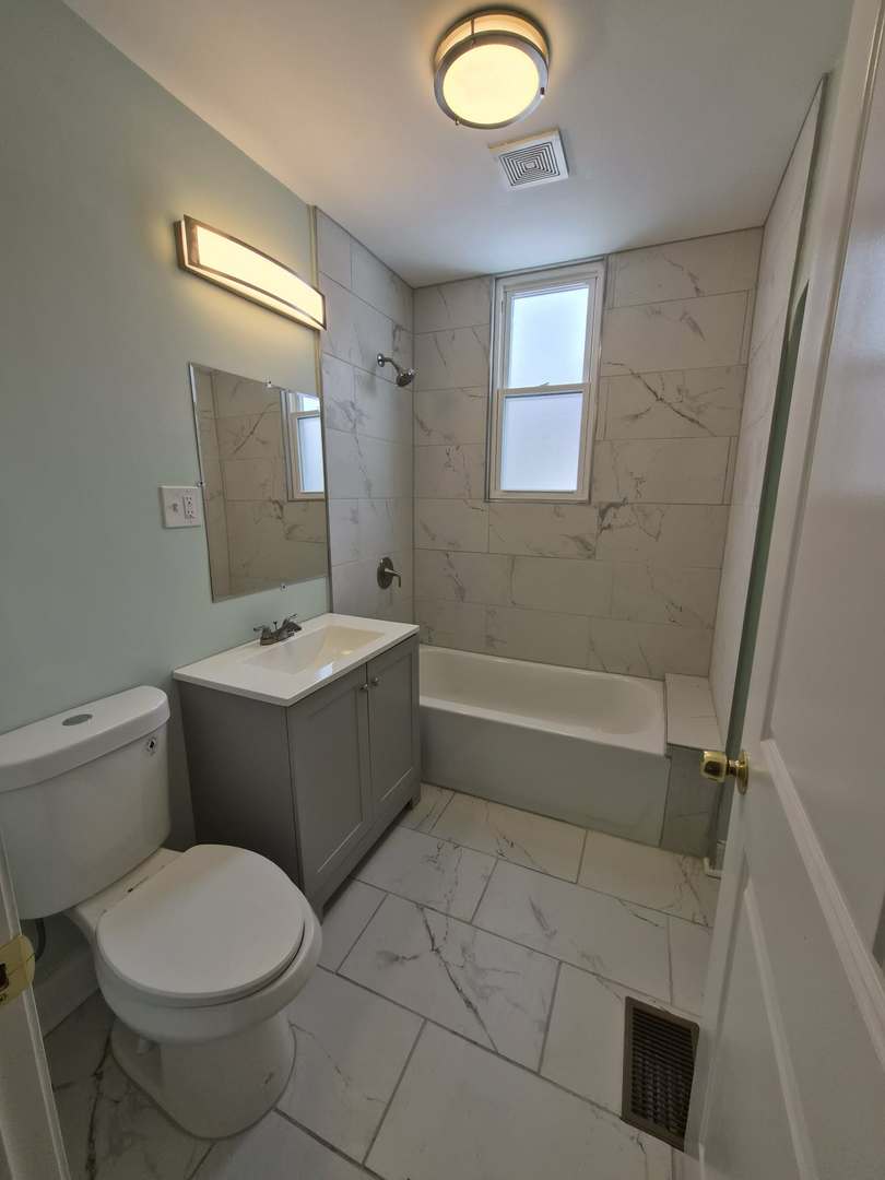 1234 West 72nd Street Chicago, IL 60636 - Photo 21 of 35 a bathroom with a toilet sink and mirror