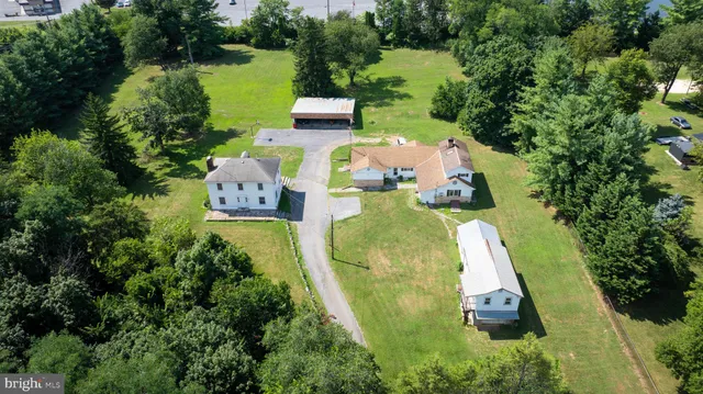 an aerial view of a house with outdoor space pool seating area and yard