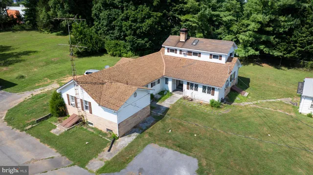 an aerial view of a house with big yard