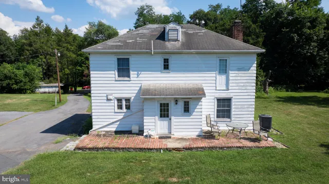 a front view of house with a garden
