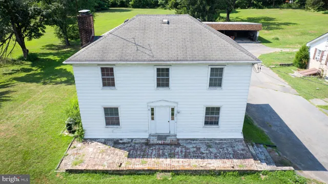 a aerial view of a house with yard and green space
