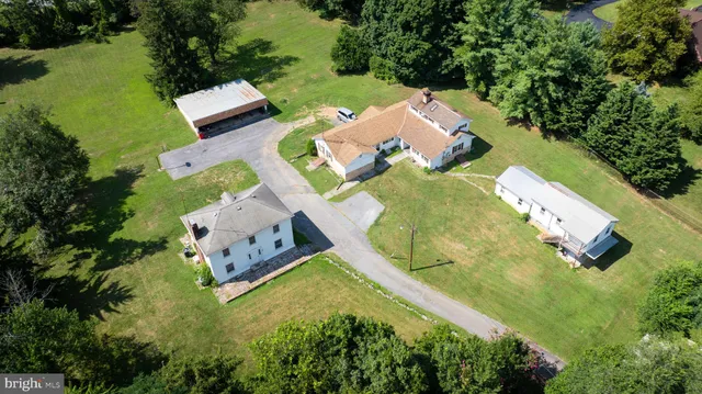 an aerial view of a house with outdoor space pool seating area and yard
