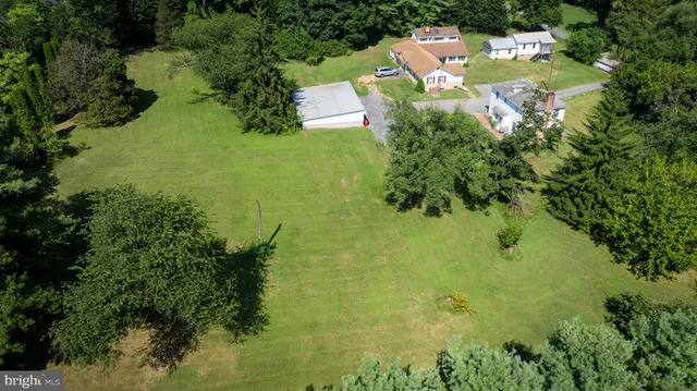 an aerial view of residential houses with yard