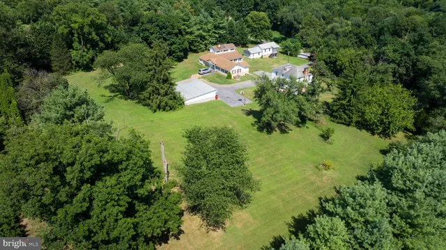 an aerial view of a house with outdoor space and street view