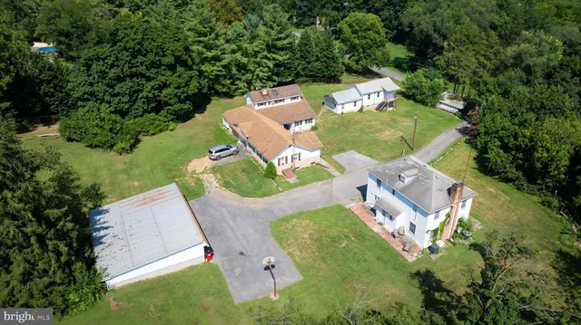 an aerial view of a house with outdoor space pool seating area and yard