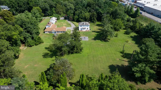 an aerial view of a house with pool outdoor seating yard and green space