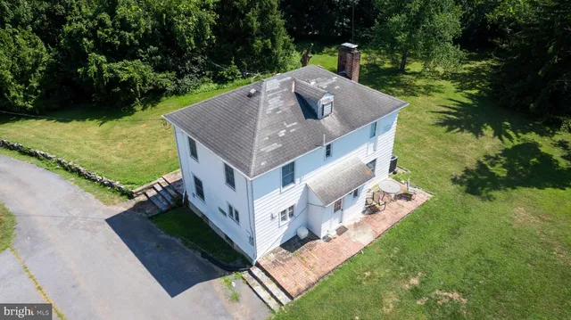a view of a house with pool and yard