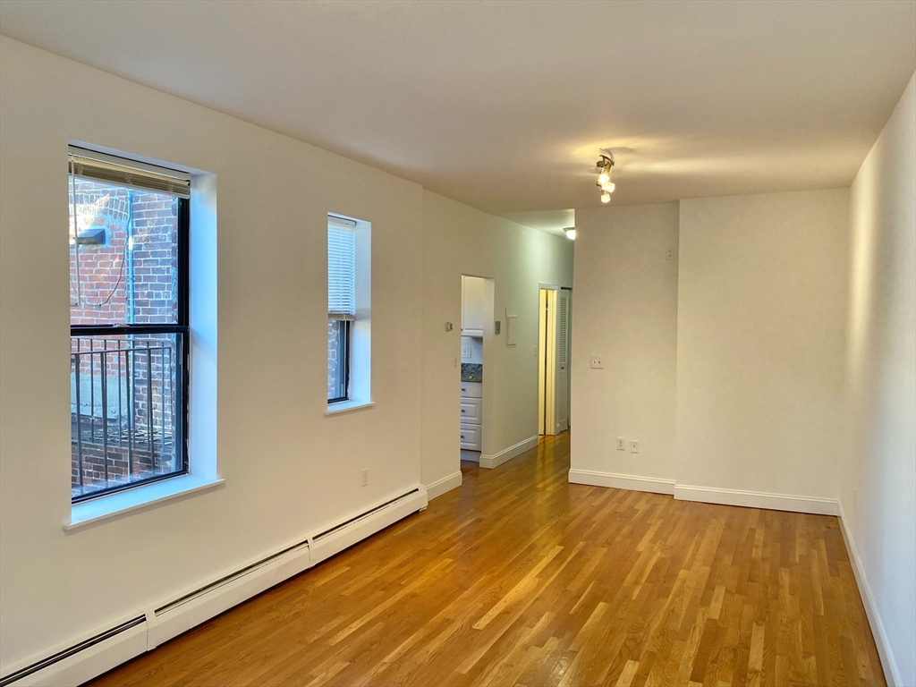 225-227 East Berkeley Street, Unit 4 Boston, MA 02118 - Photo 1 of 10 a view of an empty room with window and wooden floor