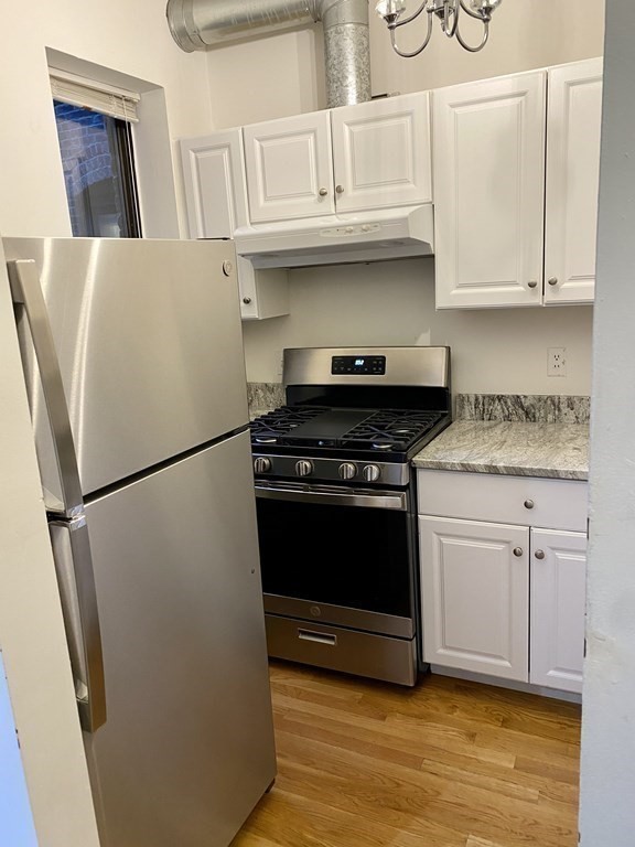 225-227 East Berkeley Street, Unit 4 Boston, MA 02118 - Photo 3 of 10 a kitchen with appliances a refrigerator and cabinets