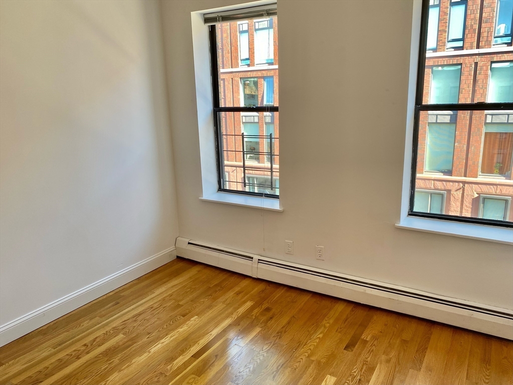 225-227 East Berkeley Street, Unit 4 Boston, MA 02118 - Photo 5 of 10 a view of a room with wooden floor and a window