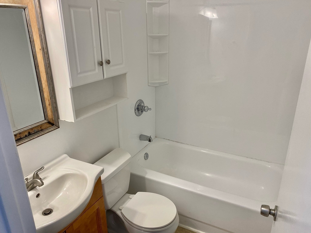 225-227 East Berkeley Street, Unit 4 Boston, MA 02118 - Photo 9 of 10 a bathroom with a sink toilet and bathtub