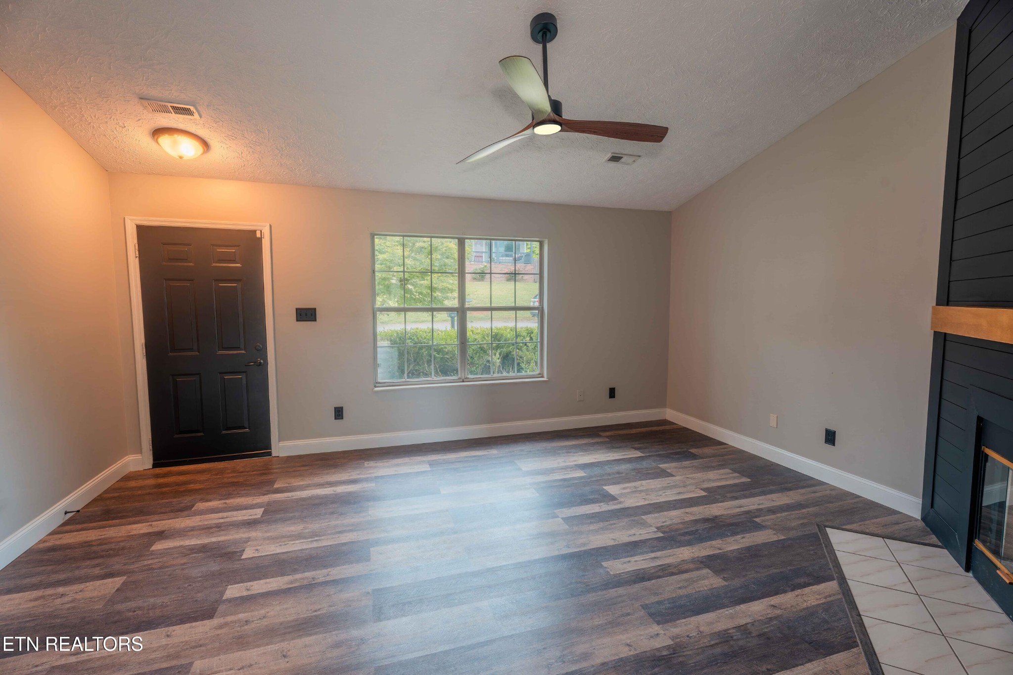 7722 Ashcroft Way Powell, TN 37849 - Photo 7 of 24 an empty room with wooden floor cabinet and windows