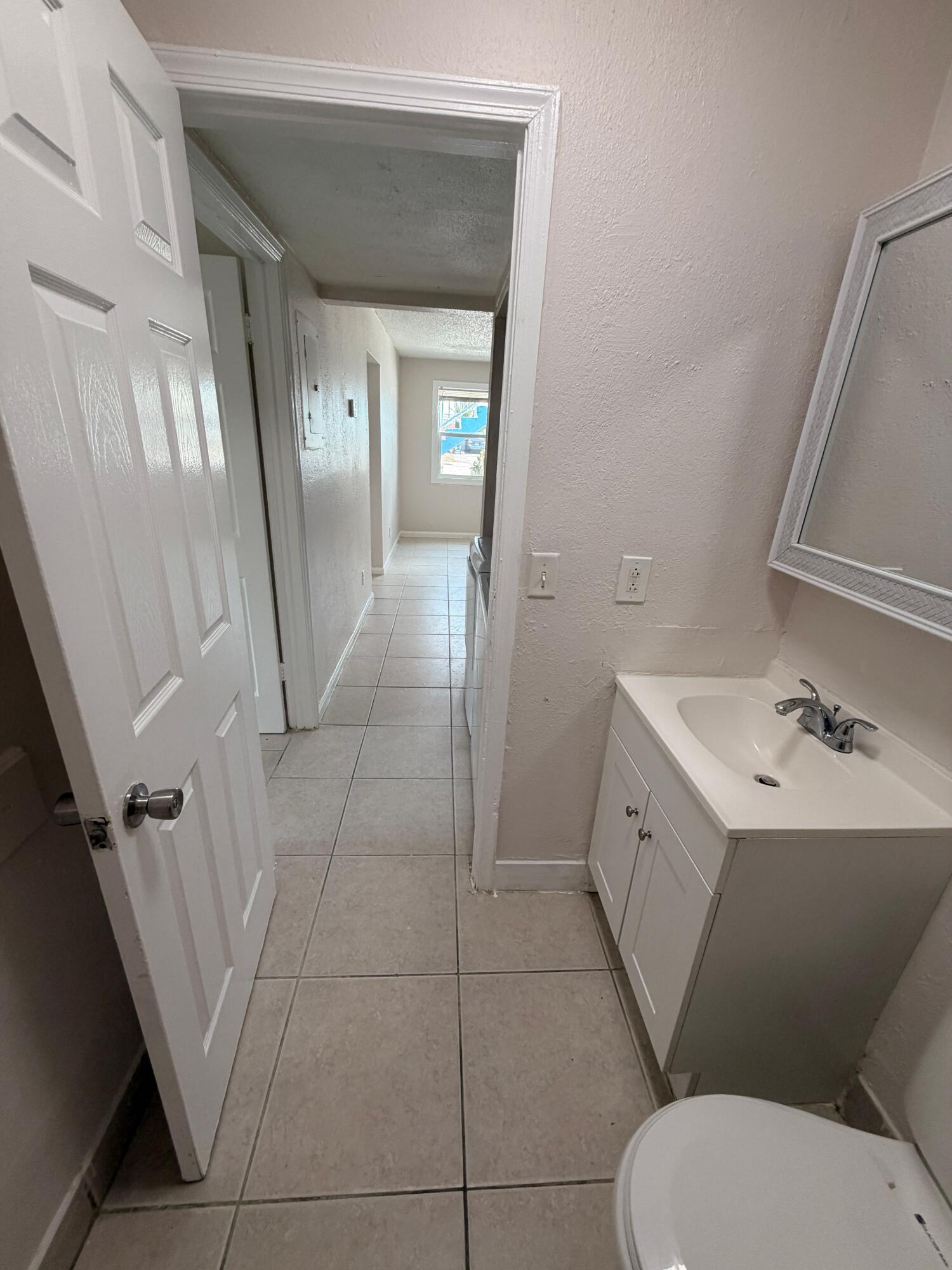 1618 West 26th Court, Unit A Riviera Beach, FL 33404 - Photo 7 of 15 a bathroom with a sink toilet and shower