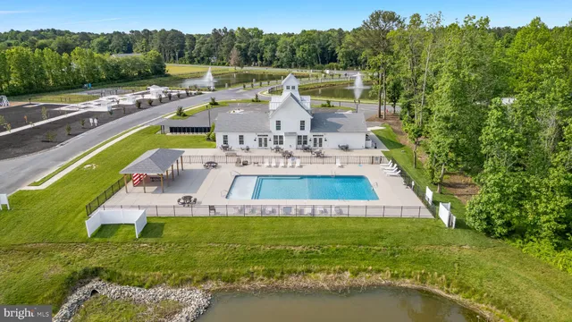 a view of a house with a yard and a fountain