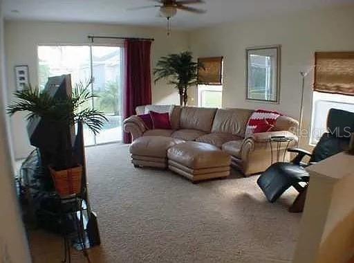 1237 Portmoor Way Winter Garden, FL 34787 - Photo 5 of 9 a living room with furniture and a flat screen tv