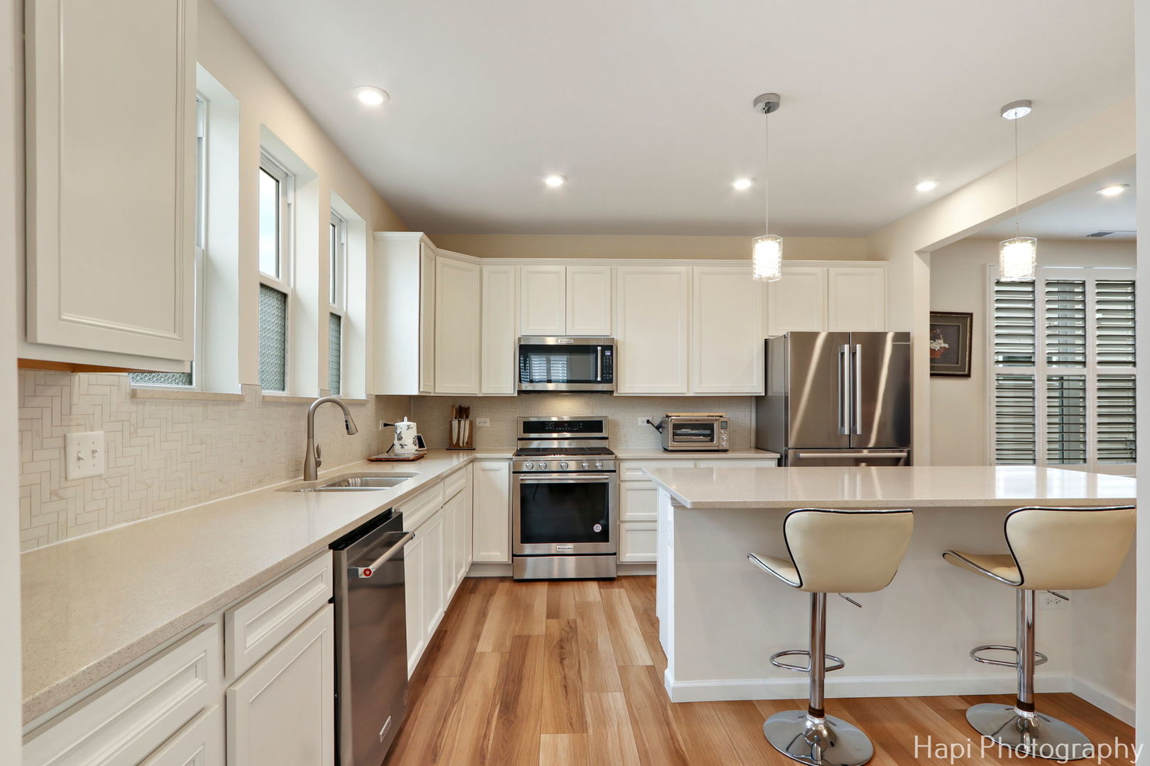 2824 Briargate Drive Lindenhurst, IL 60046 - Photo 6 of 14 a kitchen with stainless steel appliances granite countertop a stove top oven a sink dishwasher a dining table and chairs with wooden floor